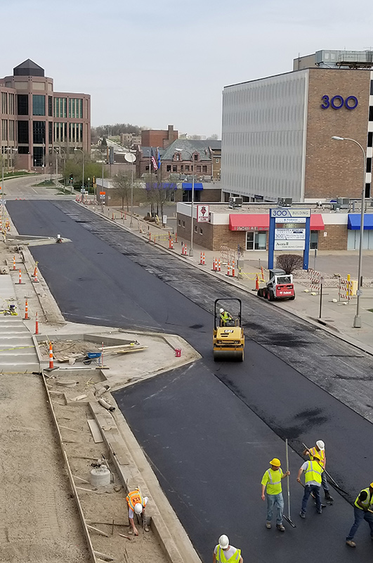 Workers pave street near Sioux Falls city downtown